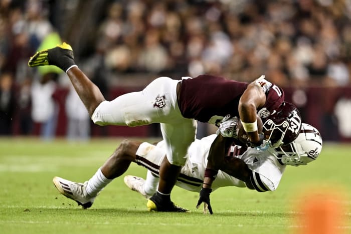 Mississippi State Bulldogs cornerback Decamerion Richardson tackles Texas A&M wide receiver Ainias Smith.